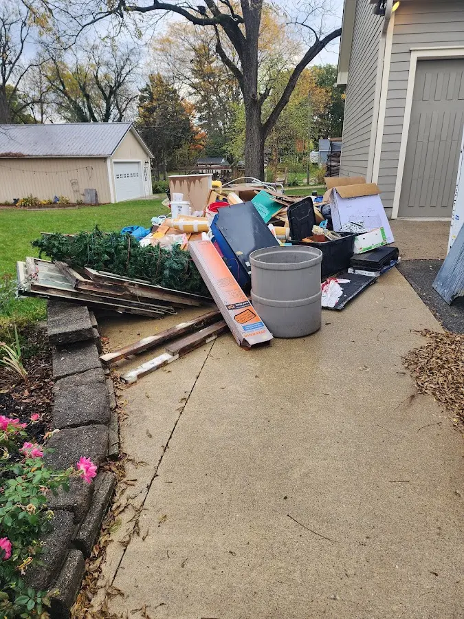 Dumpster being loaded with debris for Commercial Dumpster Rental in New Martinsville